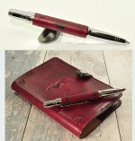 Hand stitched leather pen with paw print detail for matching leather notebook cover.jpg
